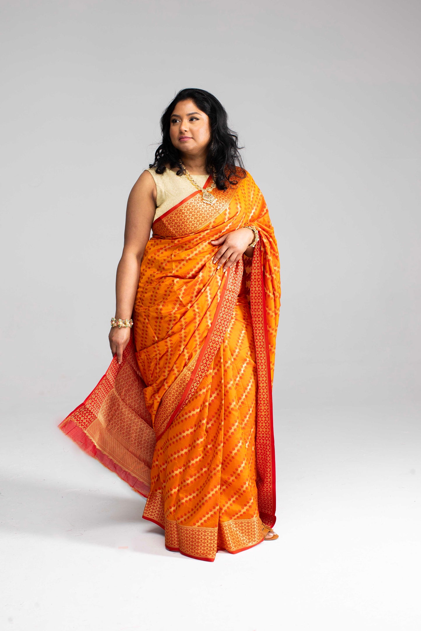 Radiant Orange Silk Saree with Gold Lines