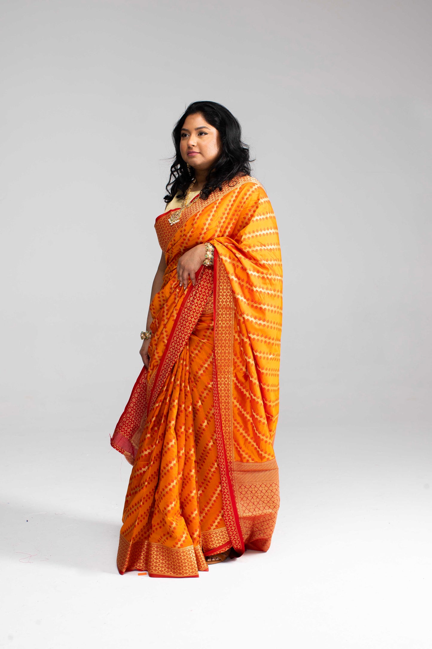 Radiant Orange Silk Saree with Gold Lines