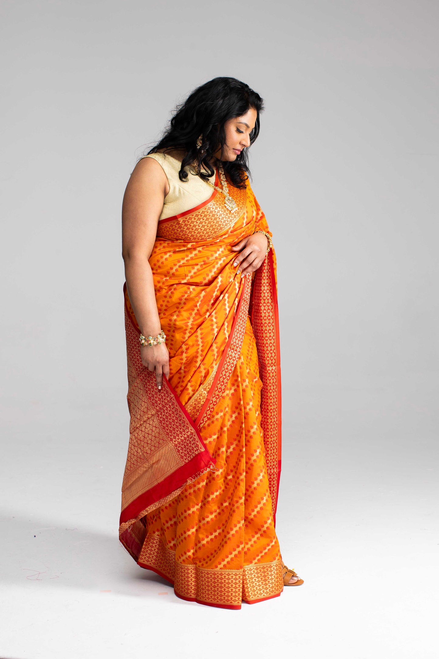 Radiant Orange Silk Saree with Gold Lines
