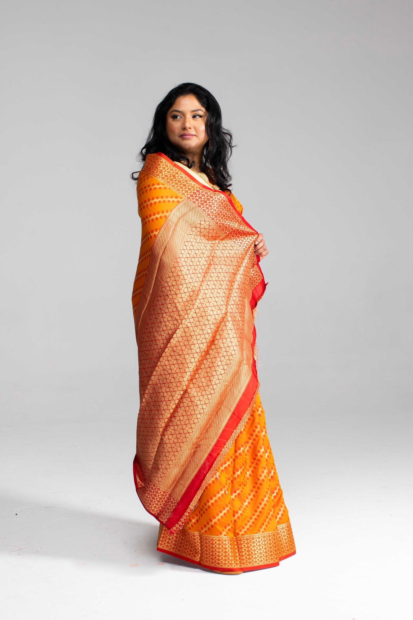 Radiant Orange Silk Saree with Gold Lines
