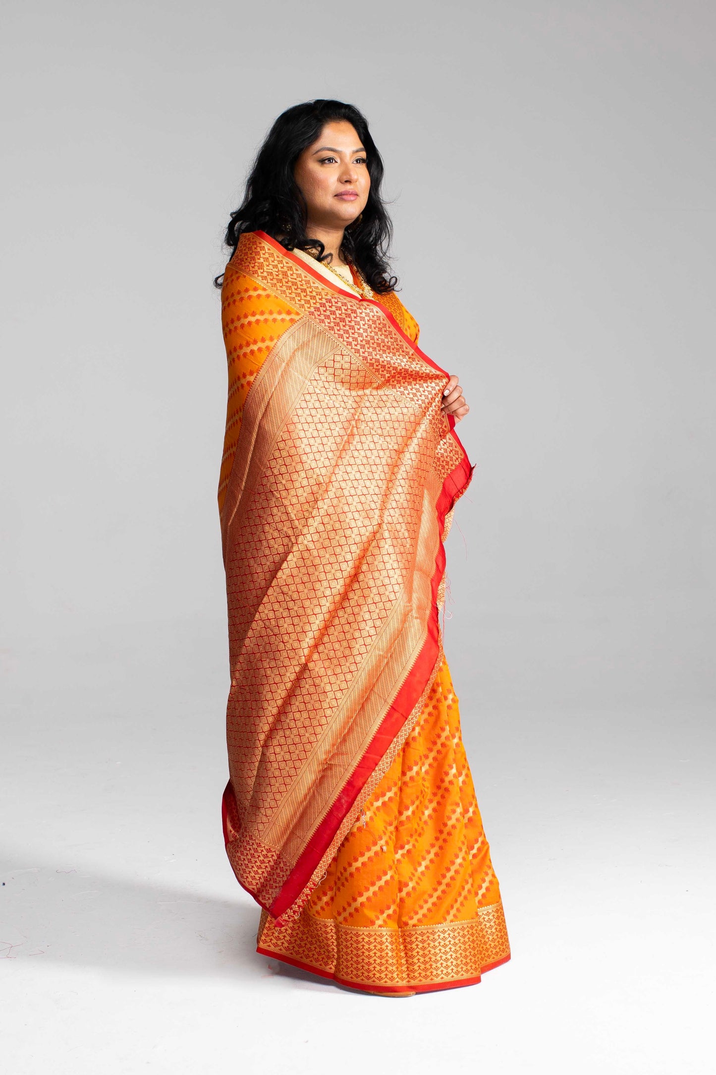 Radiant Orange Silk Saree with Gold Lines