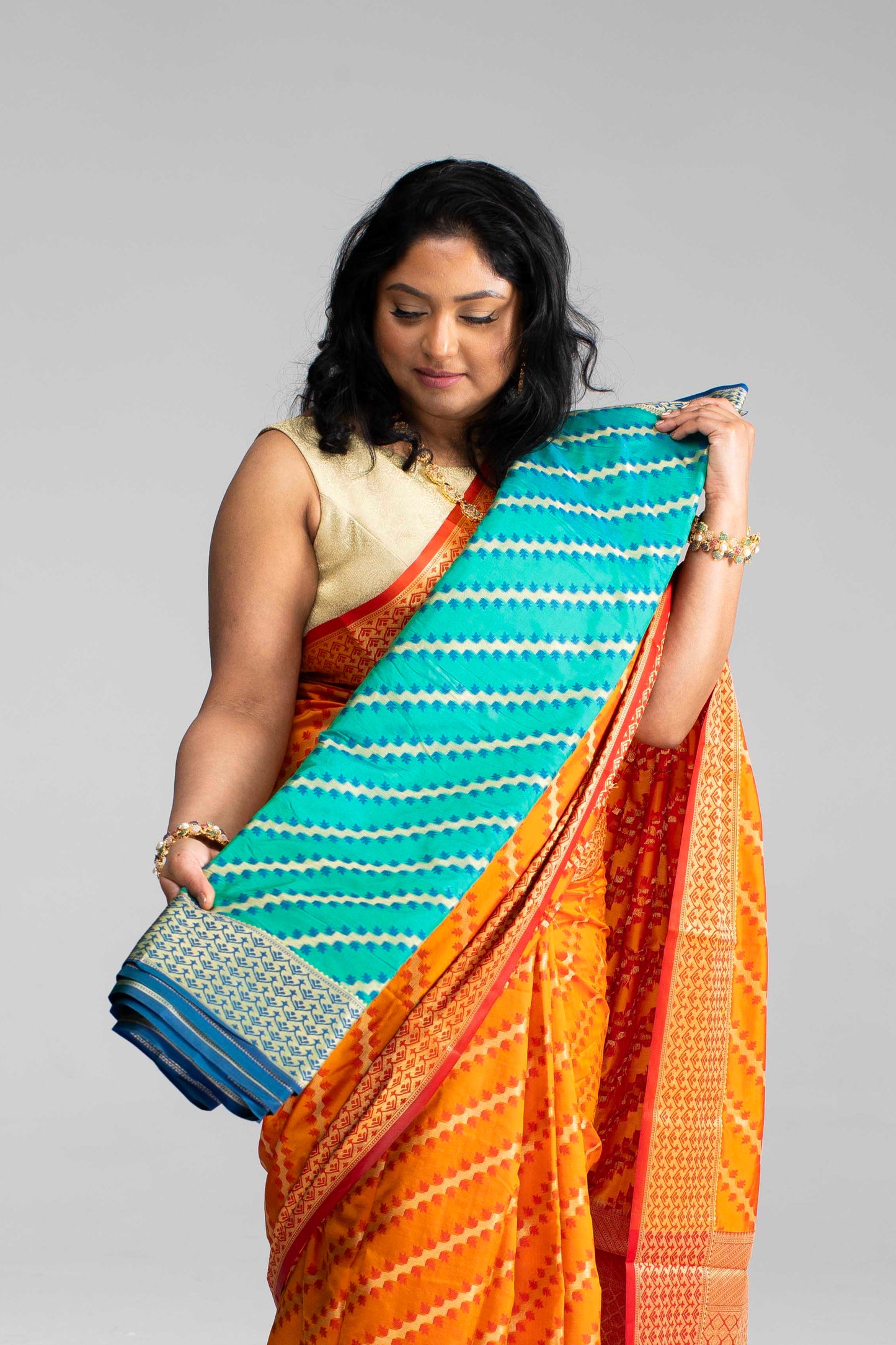 Radiant Orange Silk Saree with Gold Lines