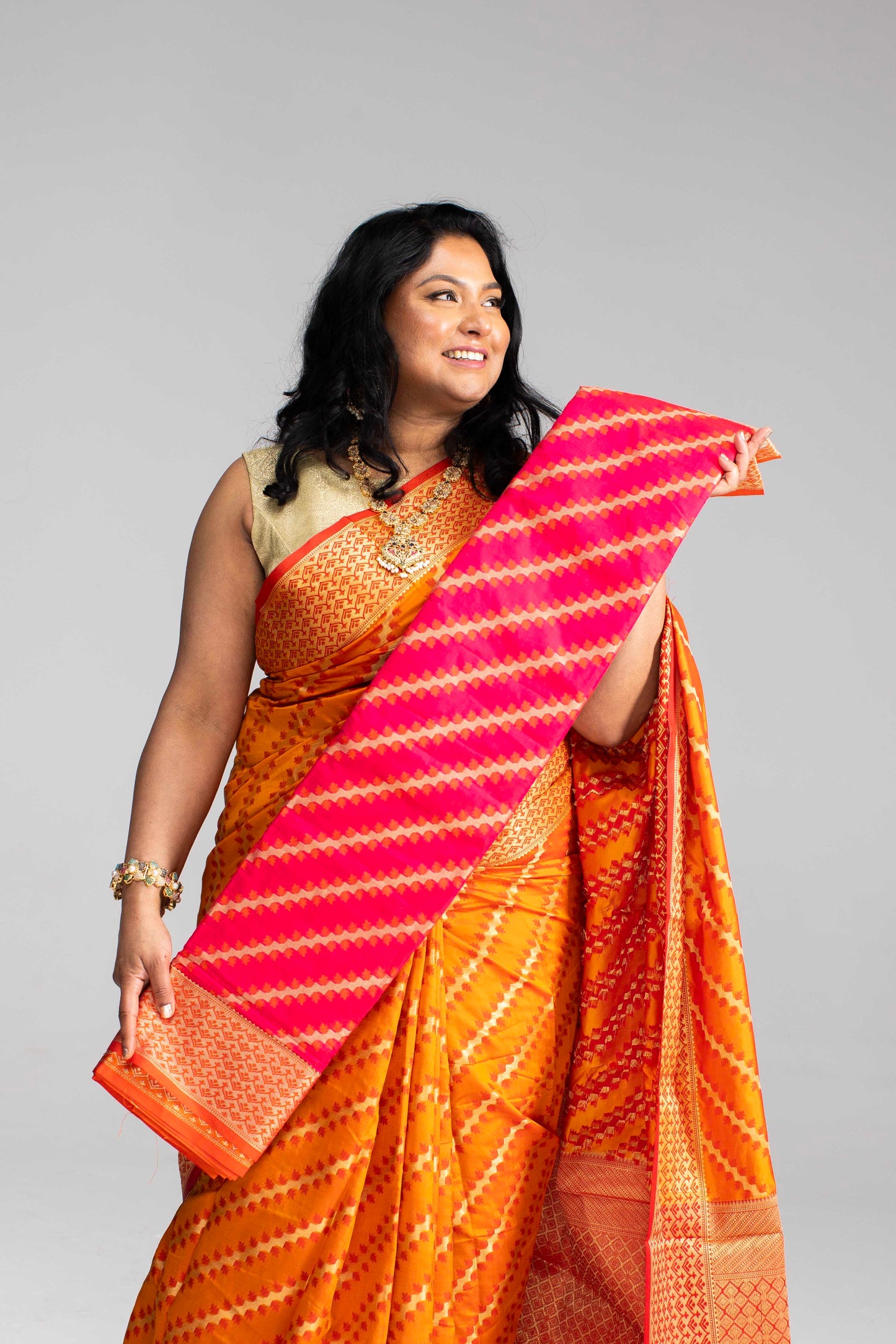 Radiant Orange Silk Saree with Gold Lines