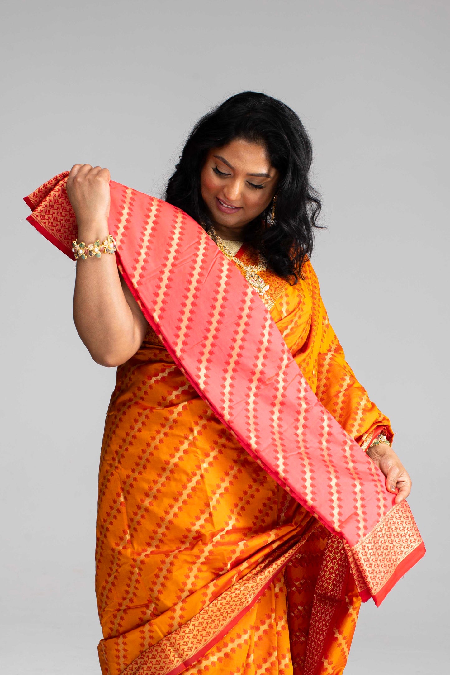 Radiant Orange Silk Saree with Gold Lines