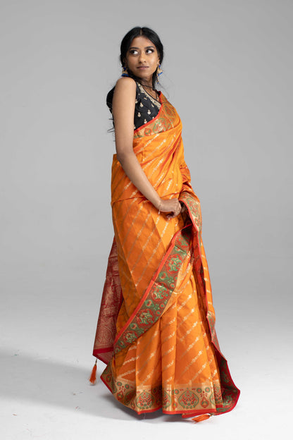 Orange Saree, featuring gold diagonal lines and a beautifully crafted border