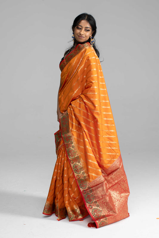 Orange Saree, featuring gold diagonal lines and a beautifully crafted border