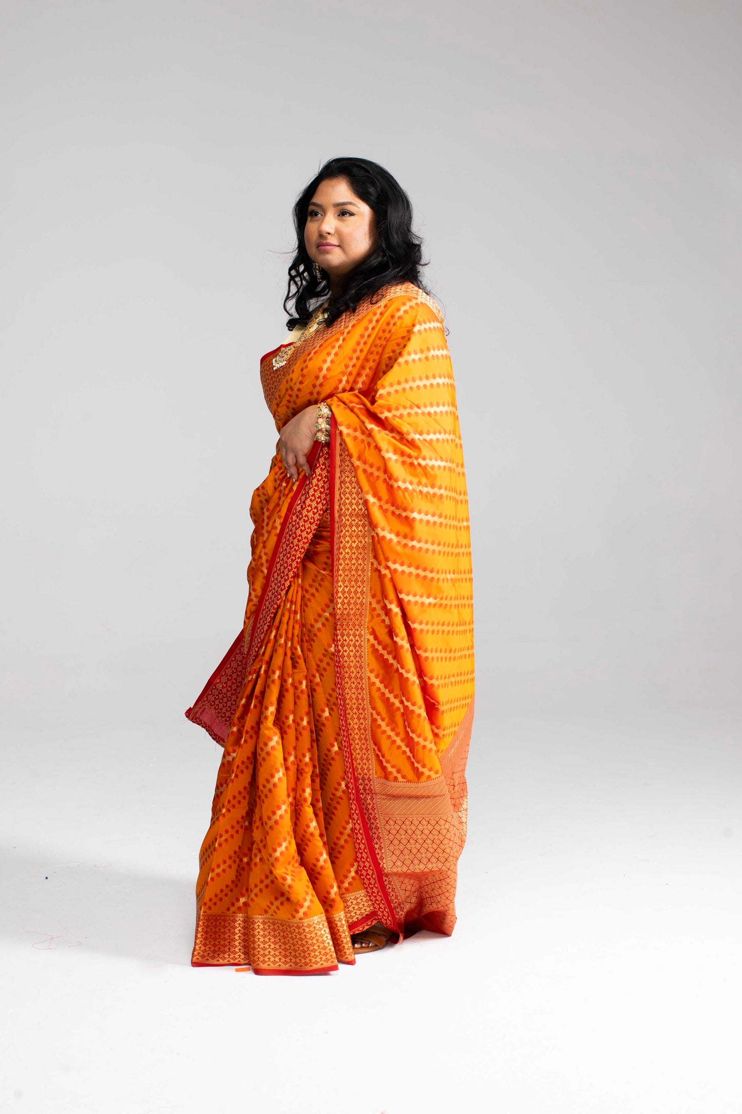 Radiant Orange Silk Saree with Gold Lines
