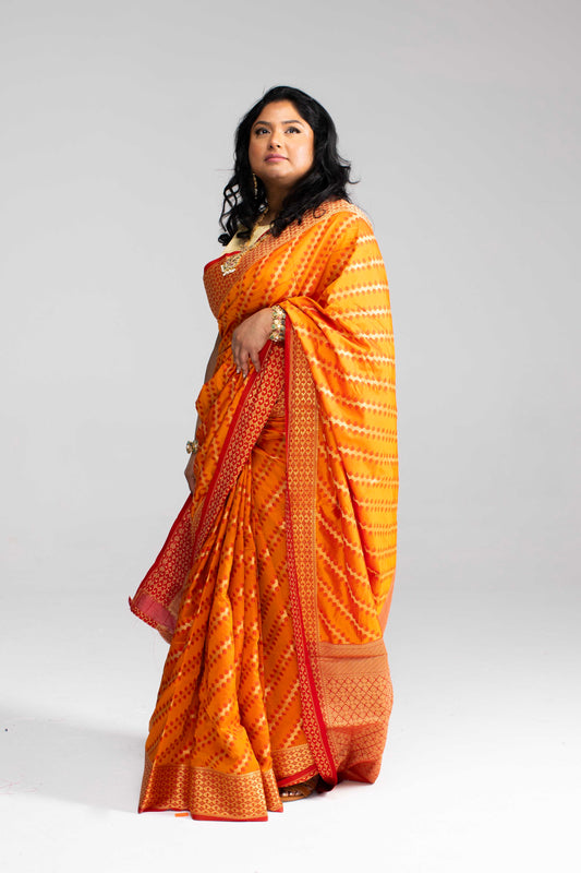 Radiant Orange Silk Saree with Gold Lines